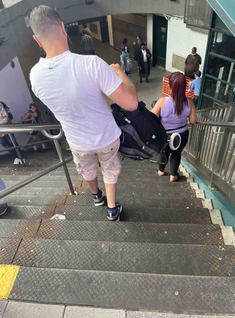 Go down the stairs in the New York City subway station.